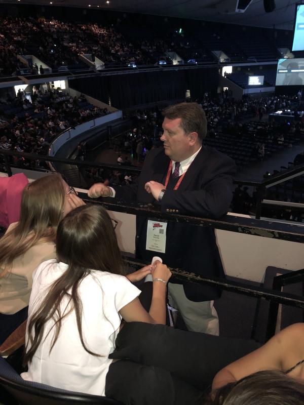 Mariner BPA advisor Daniel Shockley speaks with members Hannah Wells, left, and Natalie Longo before the 2023 National Leadership Conference Awards Ceremony.